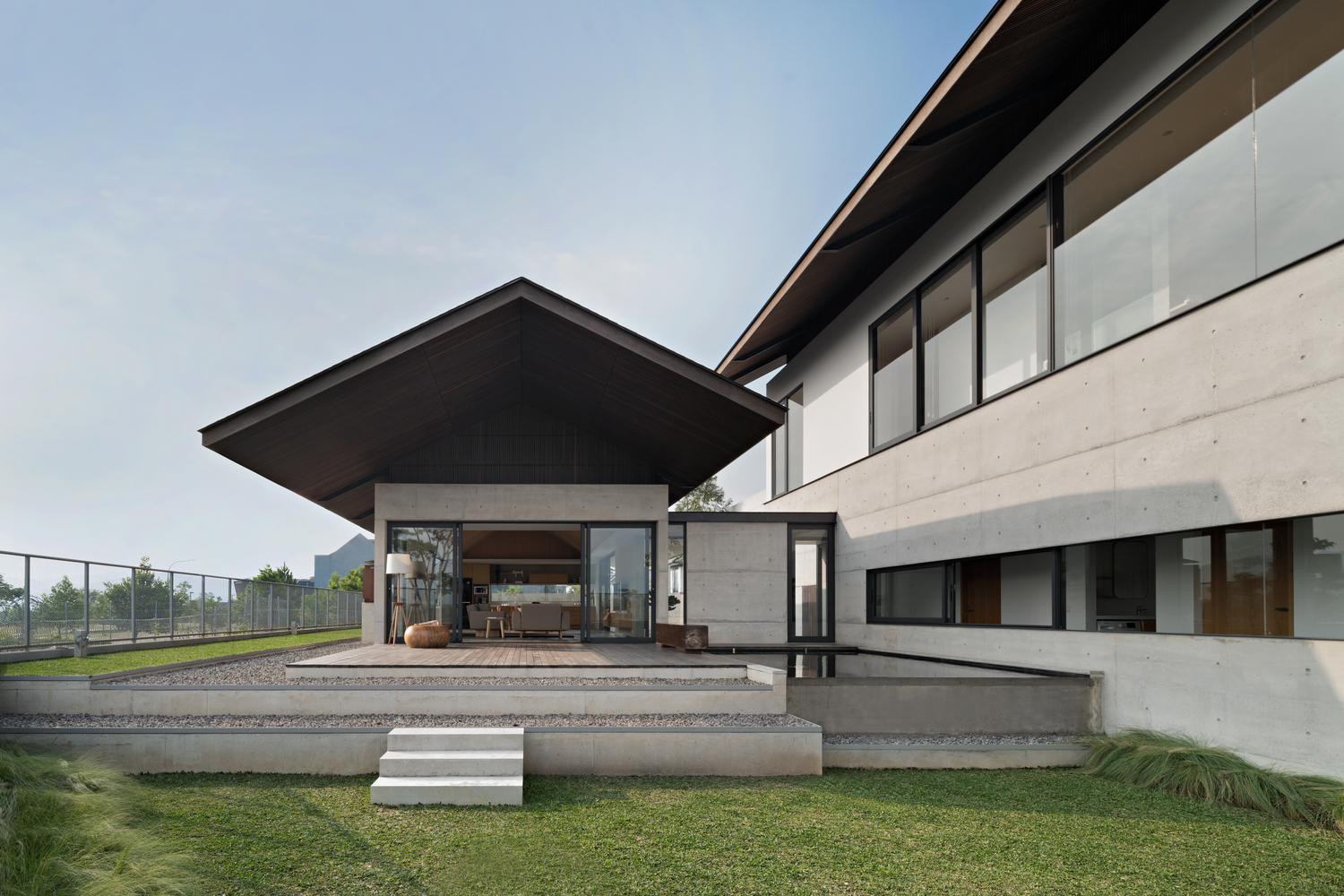 Bare concrete house with Japanese style roof