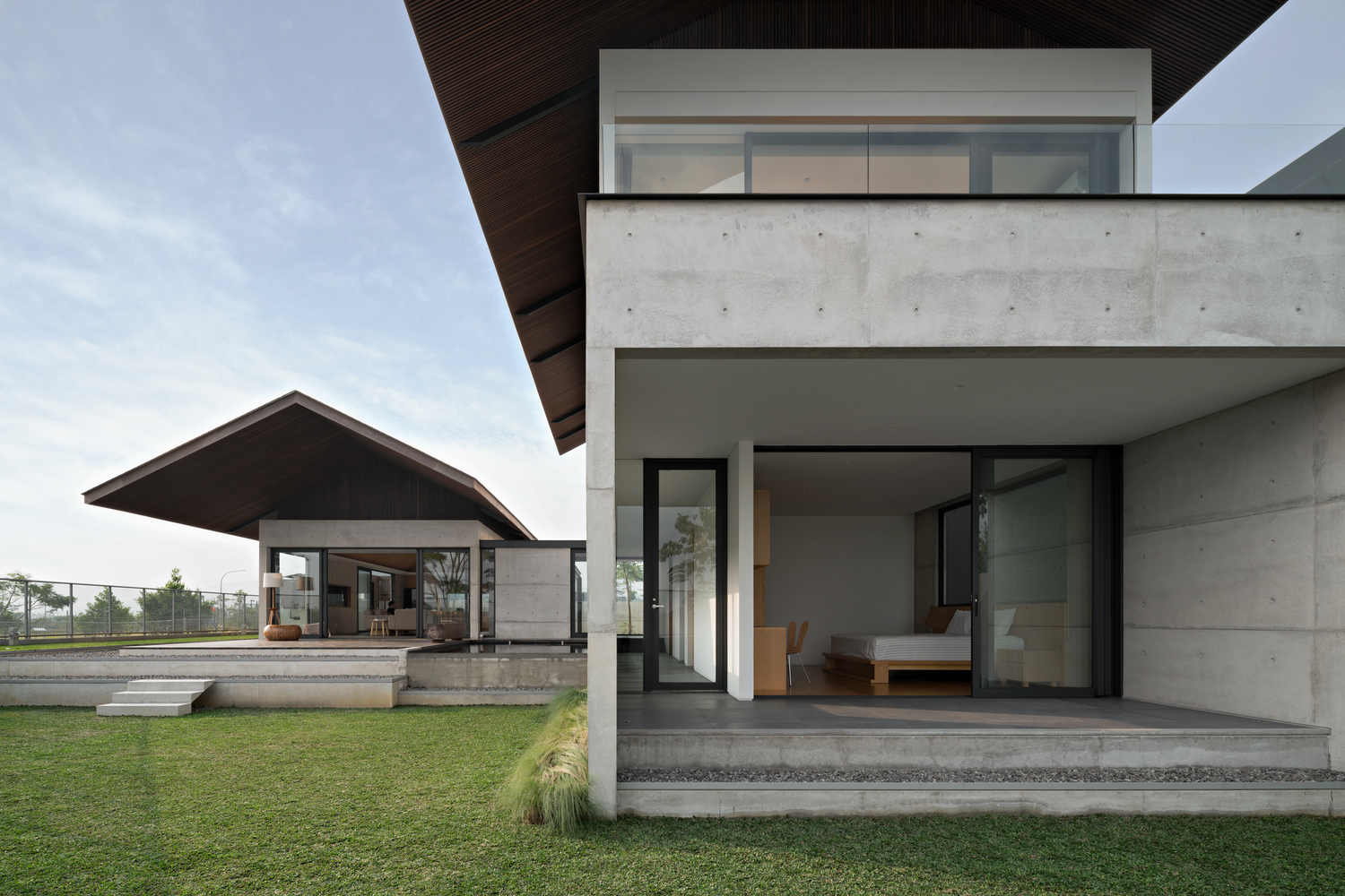 Bare concrete house with Japanese style roof