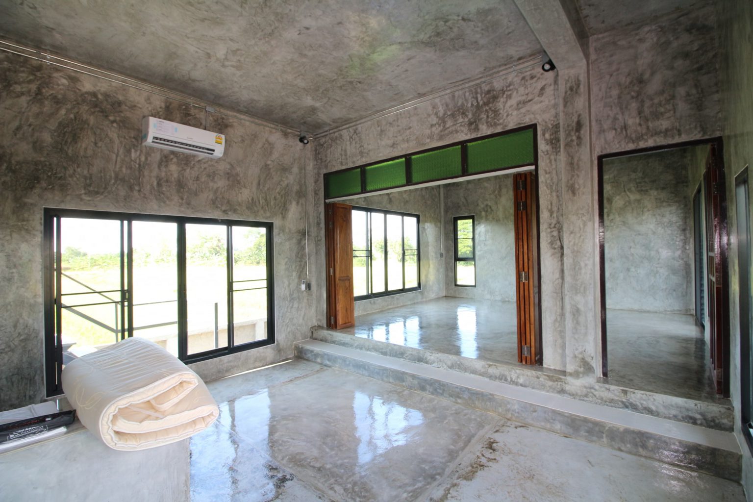 Concrete house on stilts with rural vibe