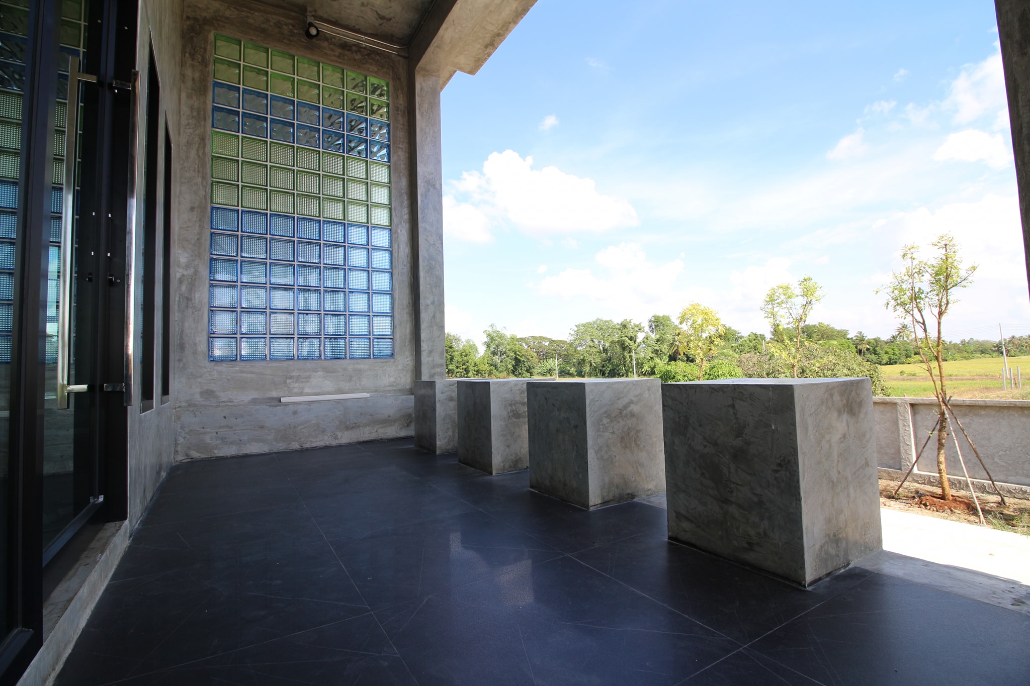 Concrete house on stilts with rural vibe
