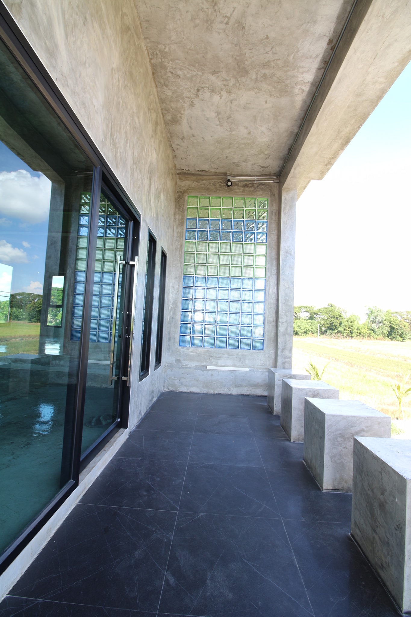 Concrete house on stilts with rural vibe