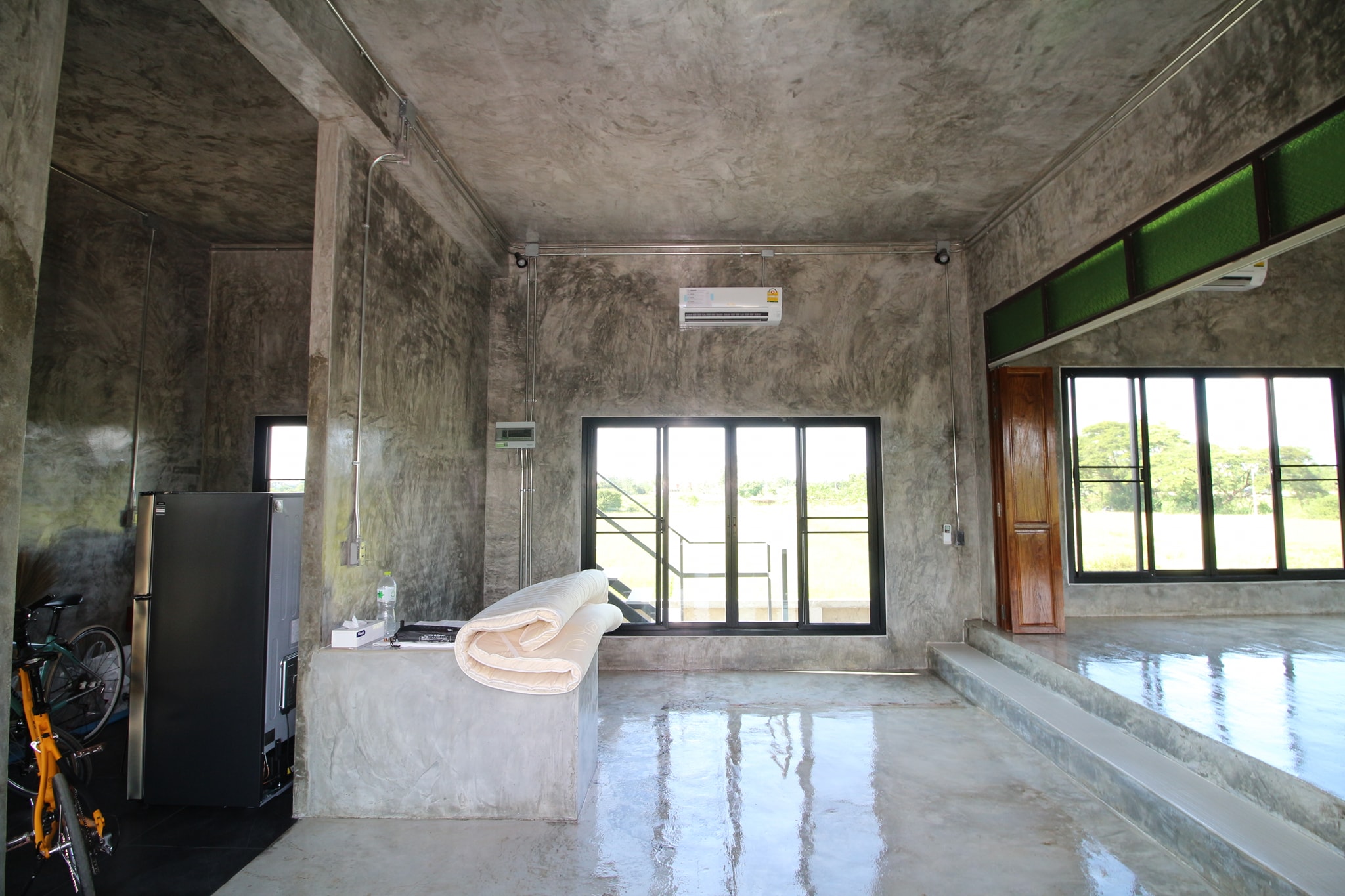 Concrete house on stilts with rural vibe